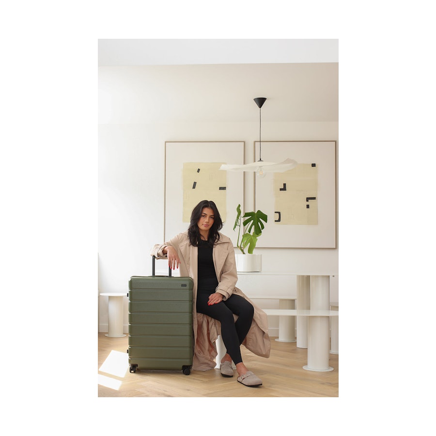 Arlo Pro Carry-On & Large Set Evergreen Model posing with Explorer Arlo Pro Large Suitcase Evergreen