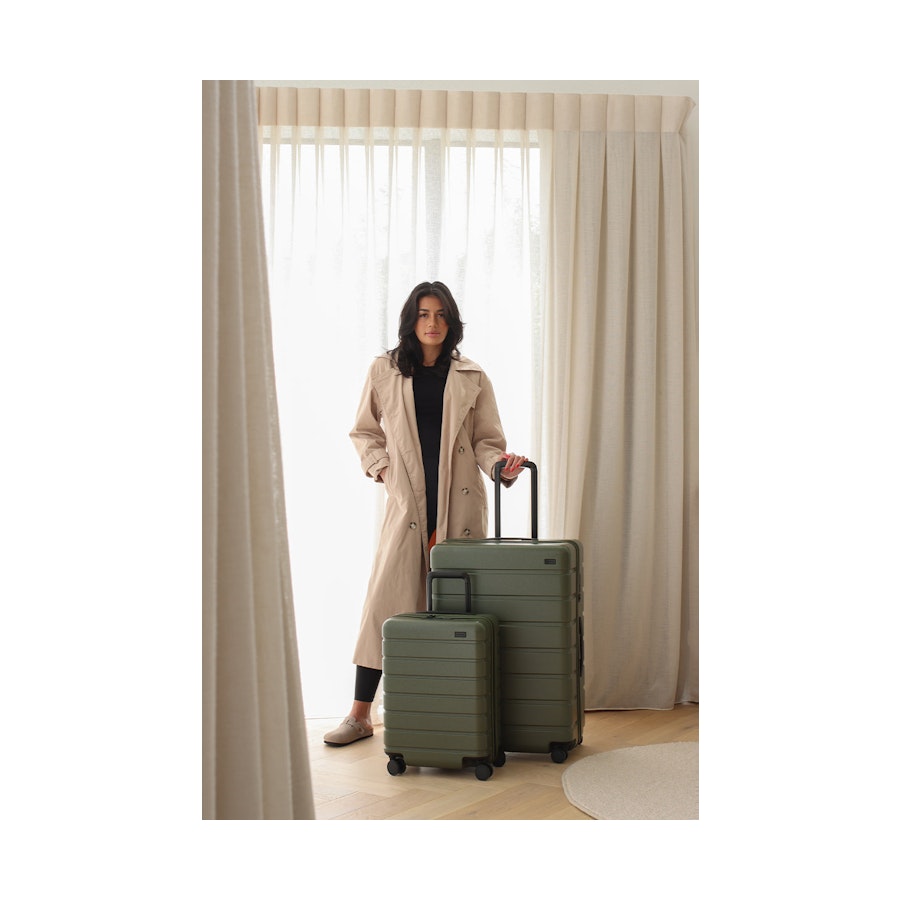Arlo Pro Carry-On & Large Set Evergreen Model posing with Explorer Arlo Pro Carry-On & Large Luggage Set Evergreen
